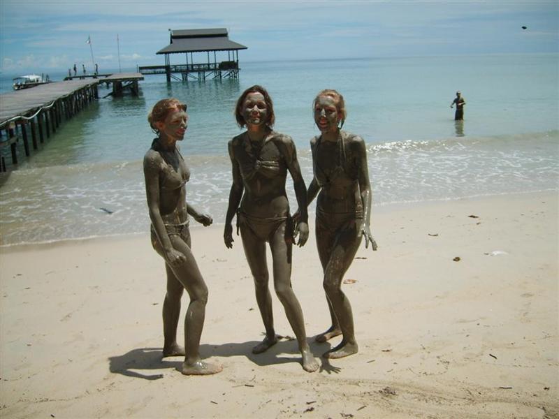 Three girls covered in mud